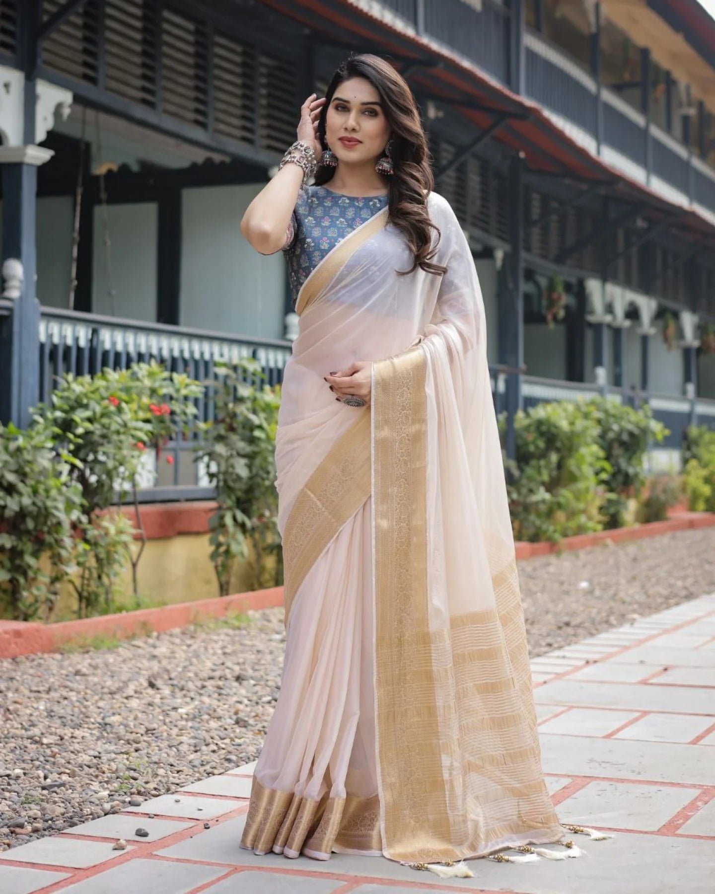 Classic cream white chiffon saree with a contrast blouse piece and a rich golden zari border
