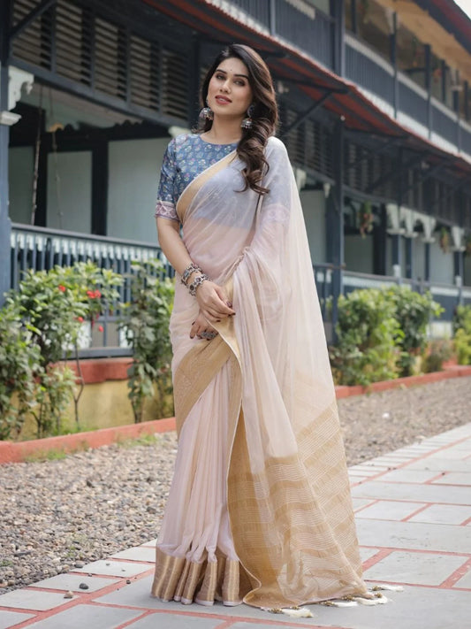 Classic cream white chiffon saree with a contrast blouse piece and a rich golden zari border