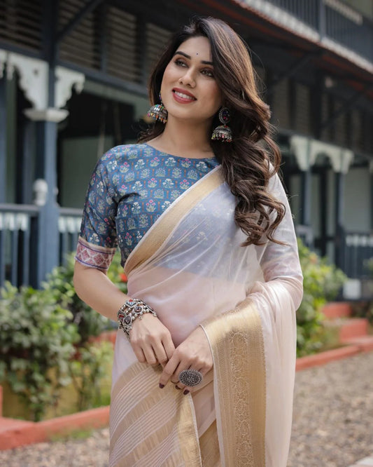 Classic cream white chiffon saree with a contrast blouse piece and a rich golden zari border